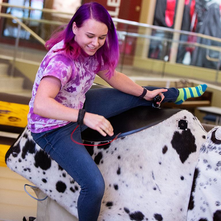 A female student on the mechanical bull