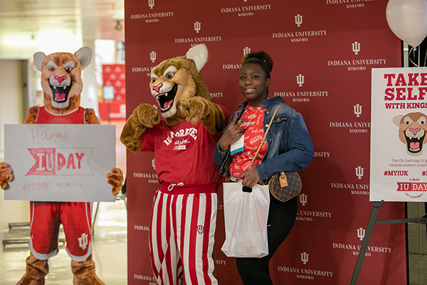 Kingston standing with an student.