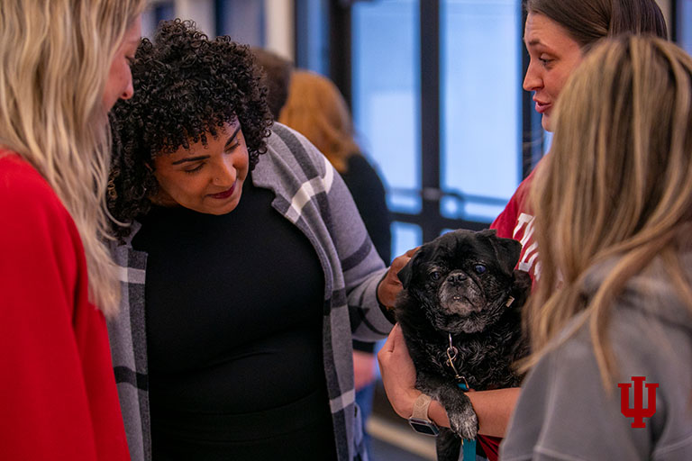 Four people and one dog inside Kelley Student Center.