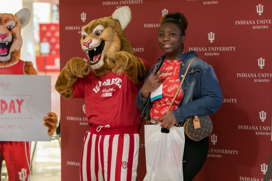 Kingston standing with a student pointing to the crowd.