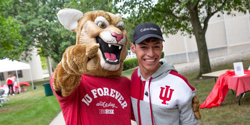 Kingston standing with a student.