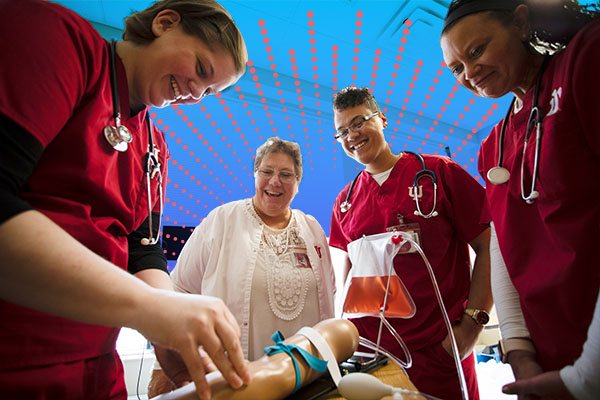 a group of nursing students working in a simulation lab