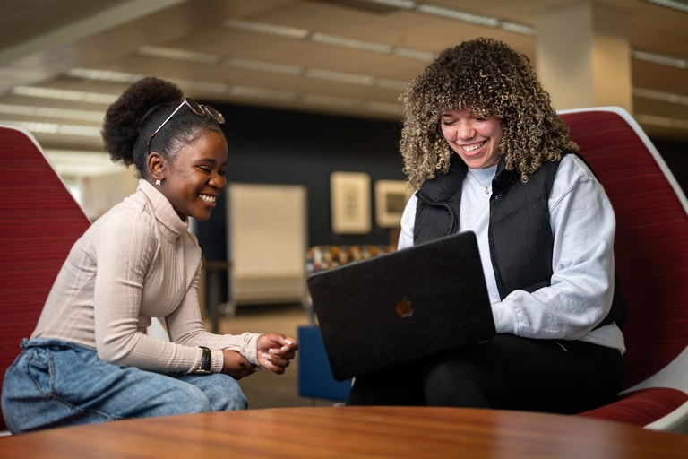 Two students studying in the library.