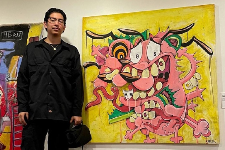 Art Student standing in front of his art work