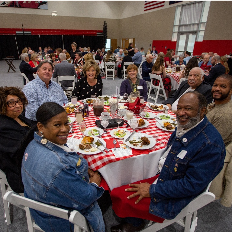 Participants sitting at a table during an event.