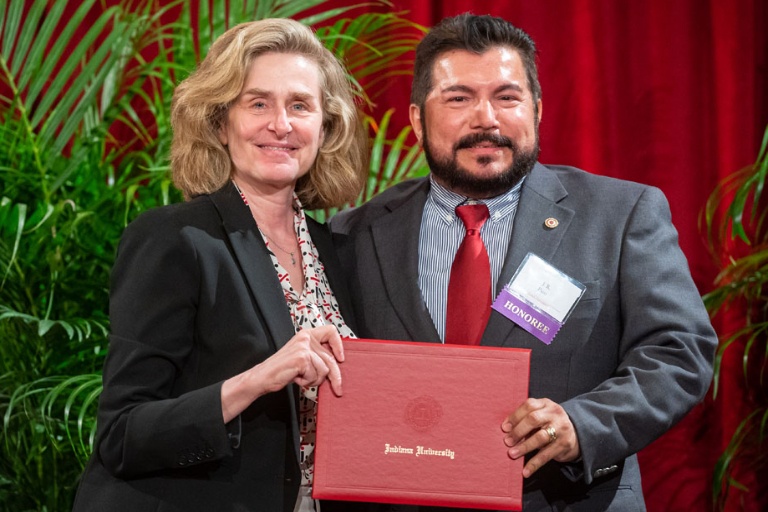 President, Pamela Whitten and faculty J.R. Pico holding a philanthropy award.